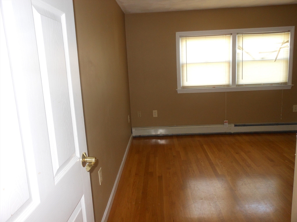 21 Cook, Unit 1 Chelsea, MA 02150 - Photo 32 of 32 a view of a room with wooden floor and a window