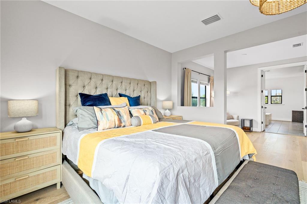 19836 Beverly Park Road Estero, FL 33928 - Photo 17 of 40 a bedroom with bed and wooden floor