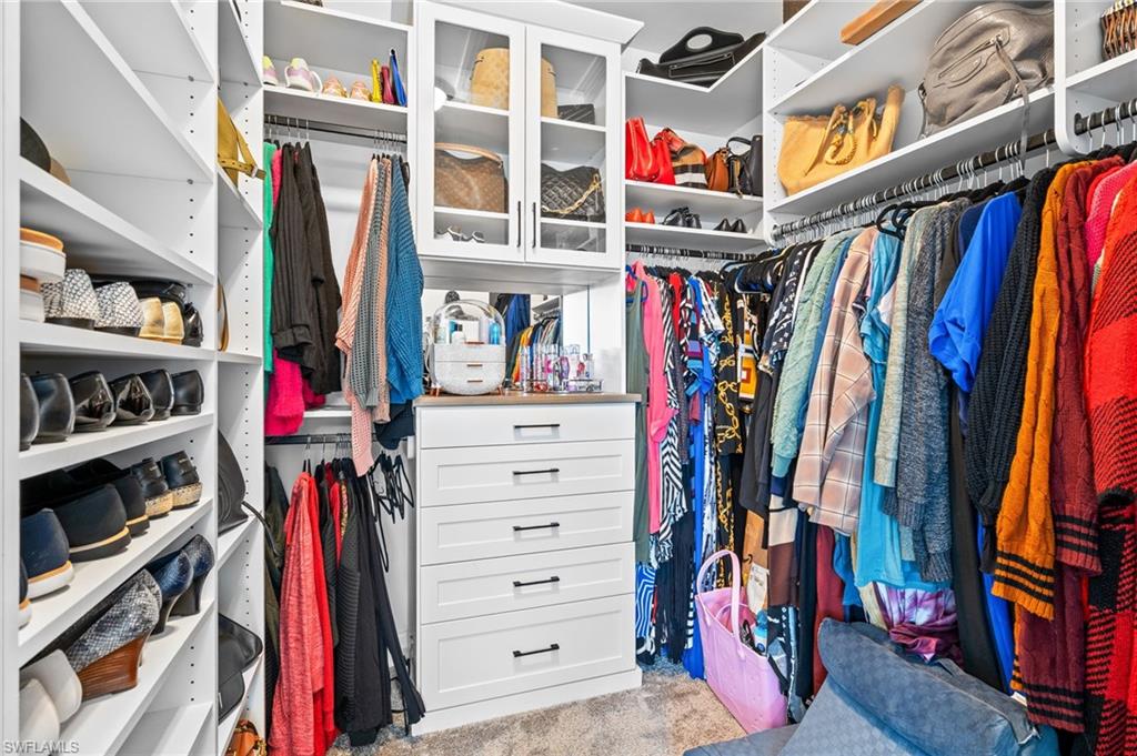 19836 Beverly Park Road Estero, FL 33928 - Photo 19 of 40 a view of walk in closet with clothes and shoes