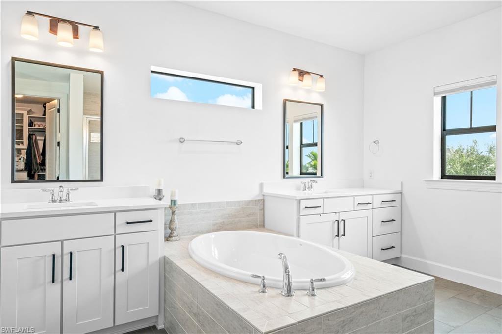 19836 Beverly Park Road Estero, FL 33928 - Photo 20 of 40 a large white kitchen with a sink and dishwasher with white cabinets