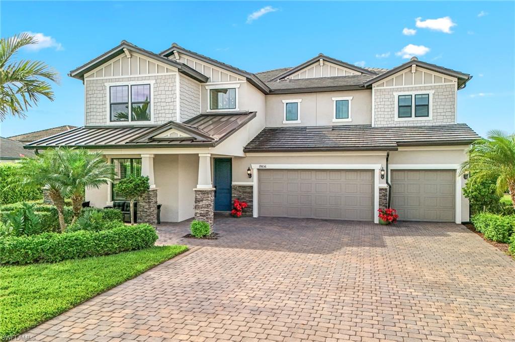 19836 Beverly Park Road Estero, FL 33928 - Photo 2 of 40 a front view of a house with a yard and garage