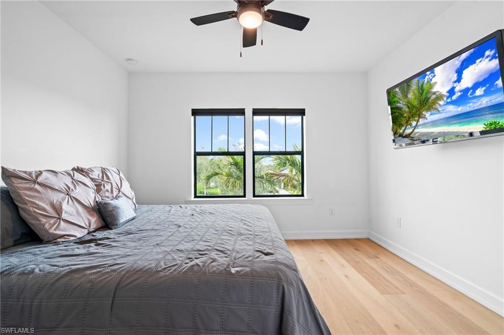 19836 Beverly Park Road Estero, FL 33928 - Photo 24 of 40 a bed sitting in a bedroom next to a window