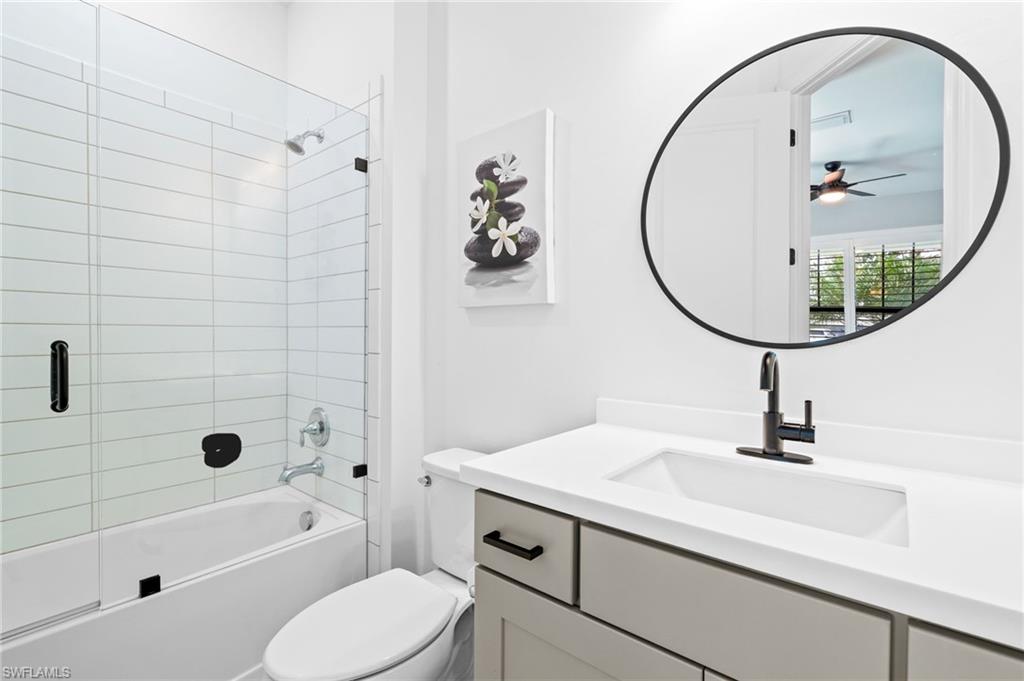19836 Beverly Park Road Estero, FL 33928 - Photo 27 of 40 a bathroom with a sink a toilet and a mirror