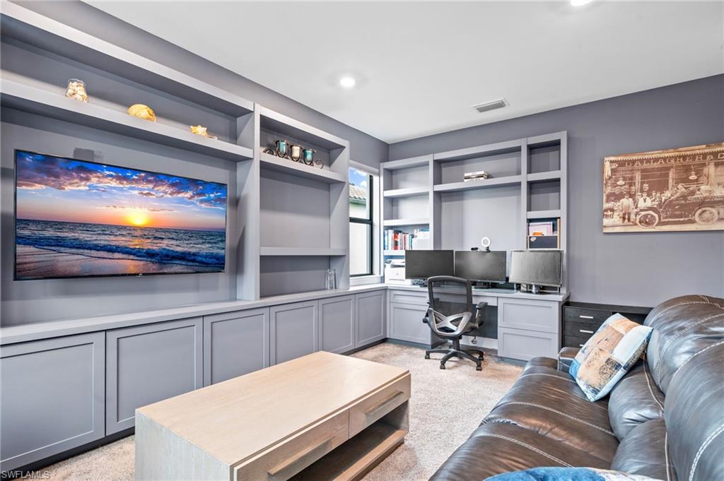 19836 Beverly Park Road Estero, FL 33928 - Photo 31 of 40 a room with furniture and a flat screen tv