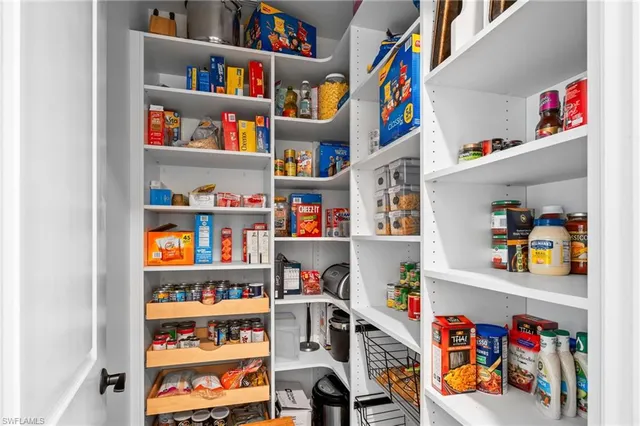 a living room with patio furniture and a potted plant