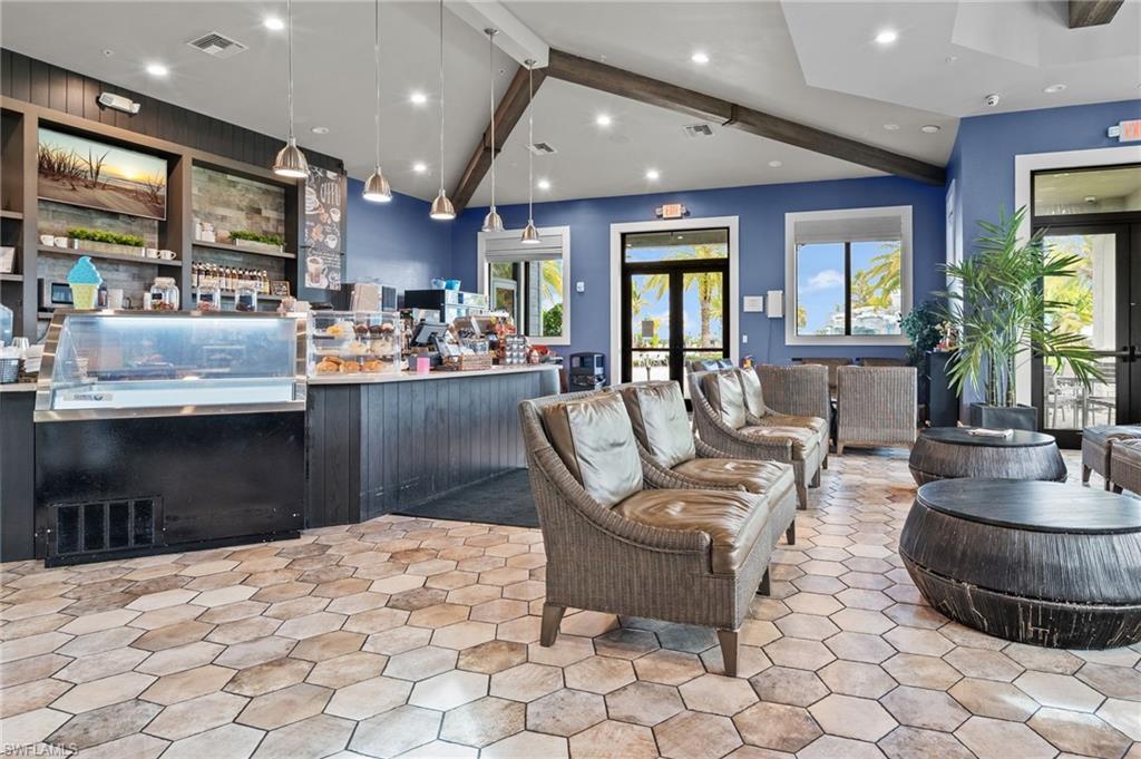 19836 Beverly Park Road Estero, FL 33928 - Photo 40 of 40 a kitchen with stainless steel appliances kitchen island granite countertop a refrigerator a sink a stove a dining table and chairs