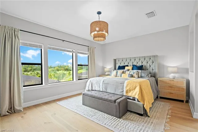 a living room with furniture a floor to ceiling window and a fireplace