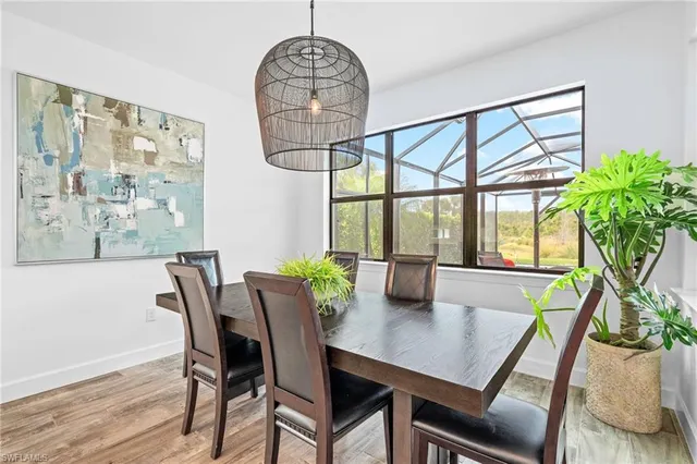 a kitchen with a stove a refrigerator a sink and white cabinets with wooden floor