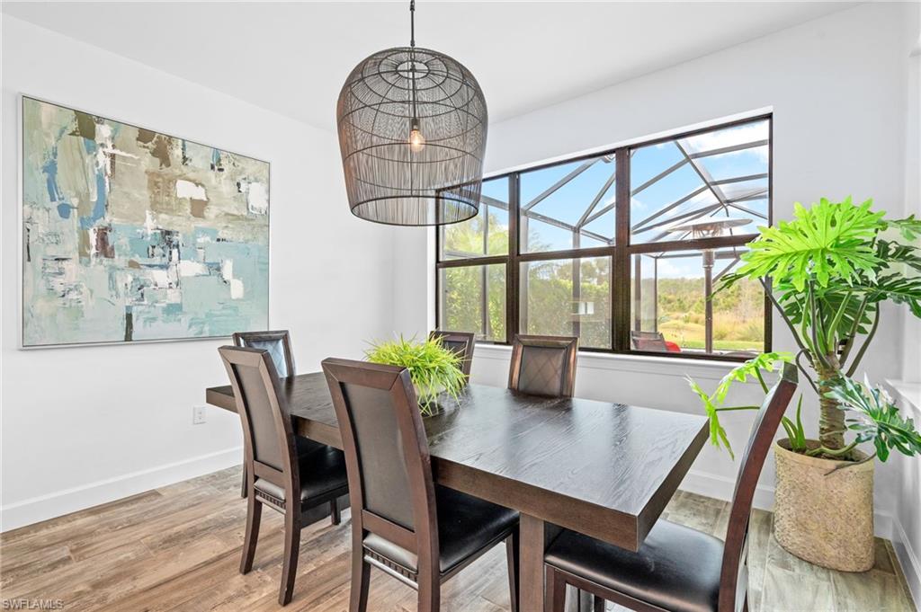 19836 Beverly Park Road Estero, FL 33928 - Photo 10 of 40 a view of a dining room with furniture window and wooden floor