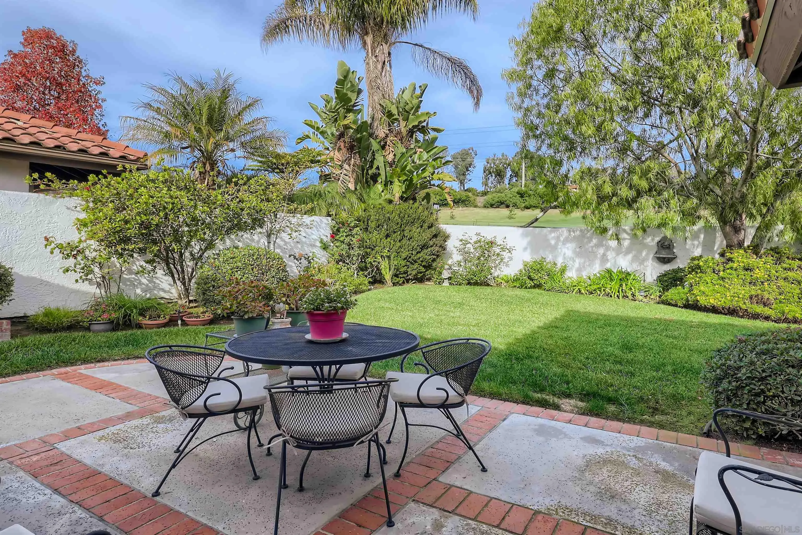 15015 Caminito Ladera Del Mar, CA 92014 - Photo 21 of 25 a view of a backyard with table and chairs couches and a fire pit