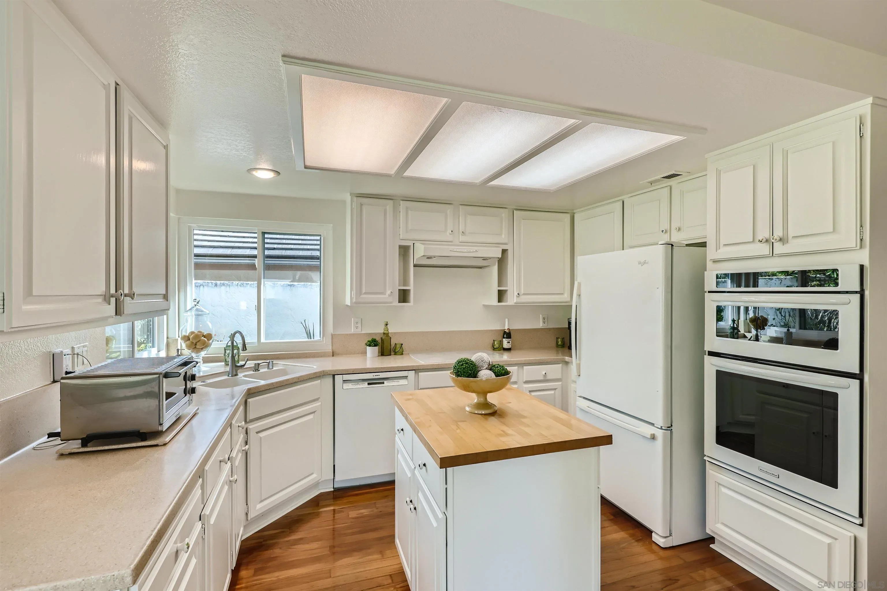15015 Caminito Ladera Del Mar, CA 92014 - Photo 10 of 25 a kitchen with a sink a stove a refrigerator and cabinets
