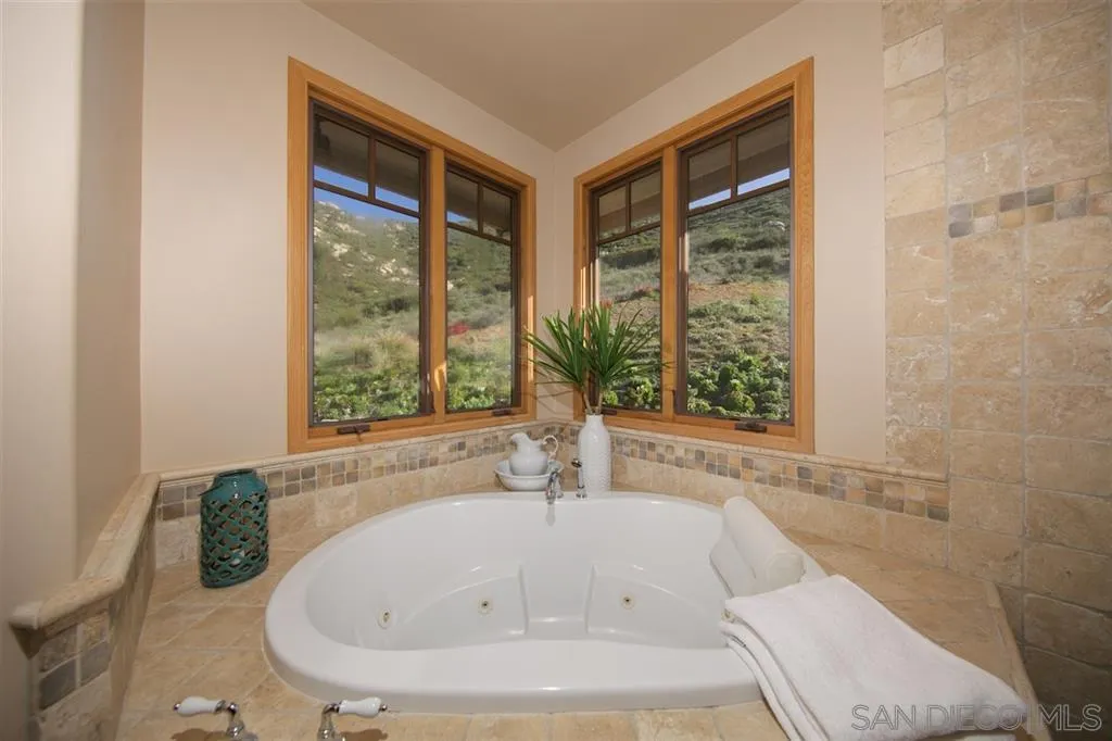 14755 Valleyview Road Poway, CA 92064 - Photo 11 of 24 a white bath tub sitting in a bathroom next to a window