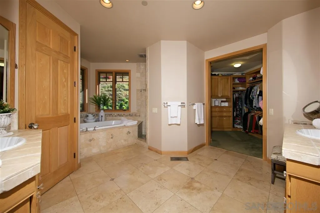 14755 Valleyview Road Poway, CA 92064 - Photo 12 of 24 a view of a bathroom with a tub shower and a sink