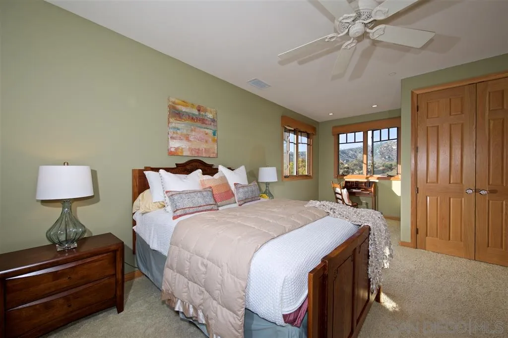 14755 Valleyview Road Poway, CA 92064 - Photo 14 of 24 a spacious bedroom with a bed and a lamp on dresser
