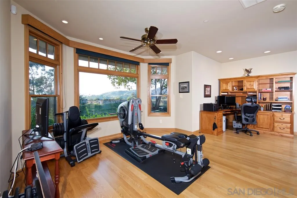 14755 Valleyview Road Poway, CA 92064 - Photo 15 of 24 a living room with furniture gym equipment and a large window