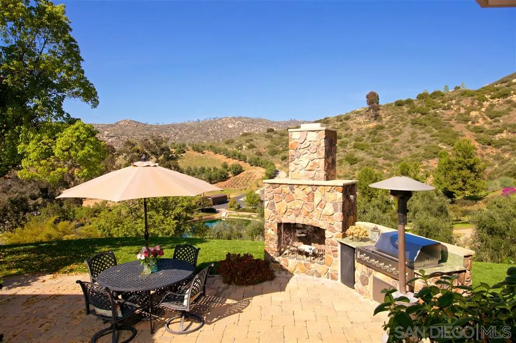 14755 Valleyview Road Poway, CA 92064 - Photo 18 of 24 a view of a patio with chairs under an umbrella