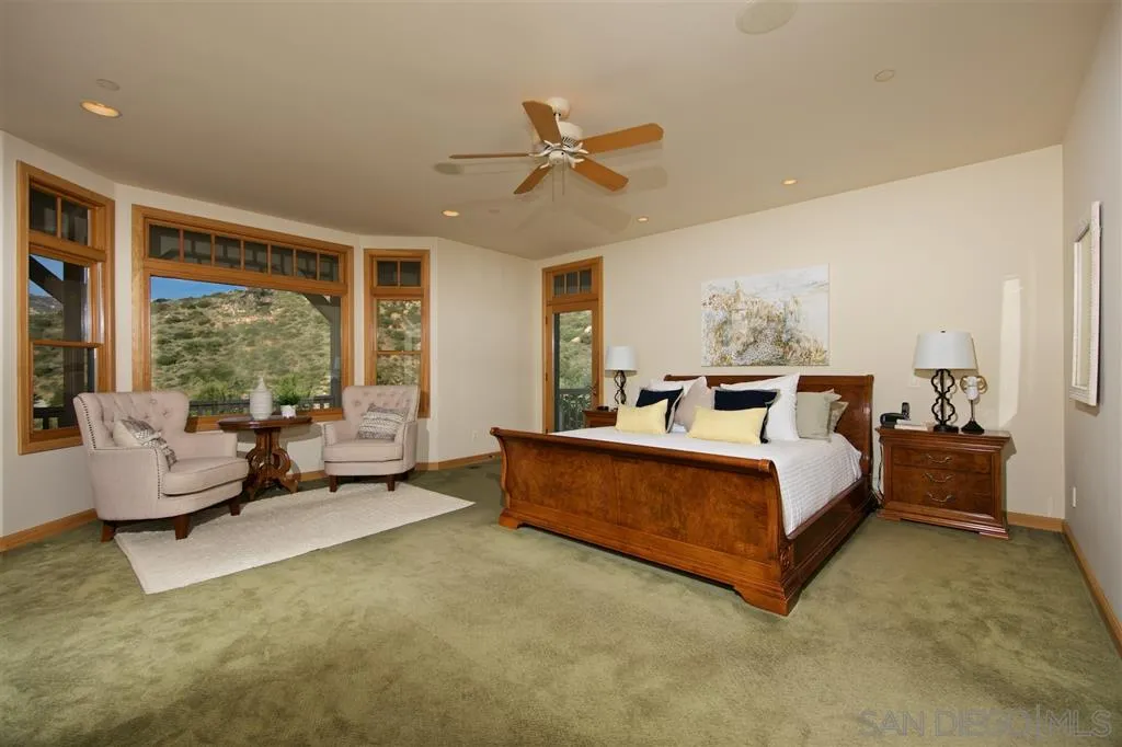 14755 Valleyview Road Poway, CA 92064 - Photo 9 of 24 a spacious bedroom with a bed and large window