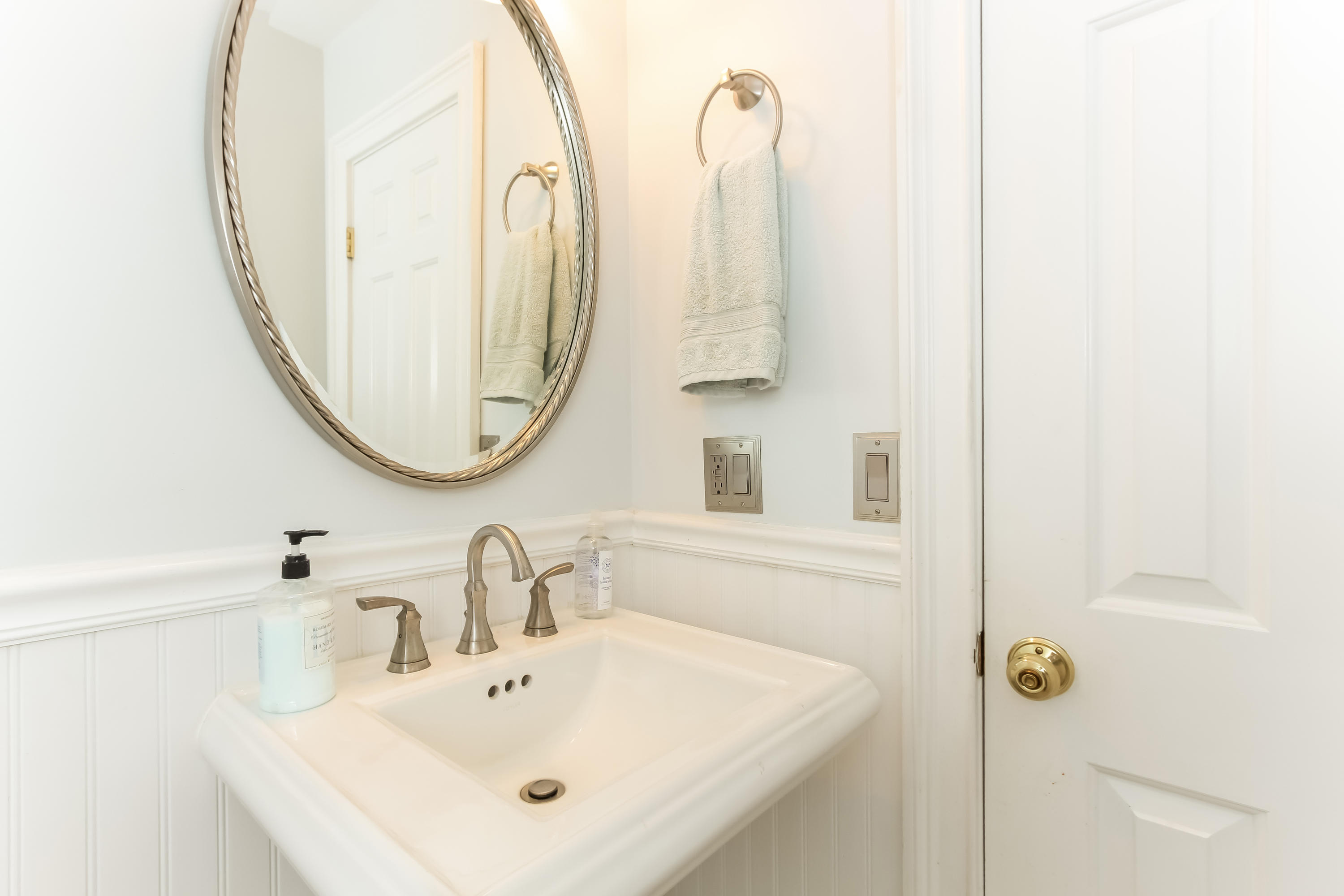 31 Miller Road Darien, CT 06820 - Photo 15 of 29 a bathroom with a sink and a mirror