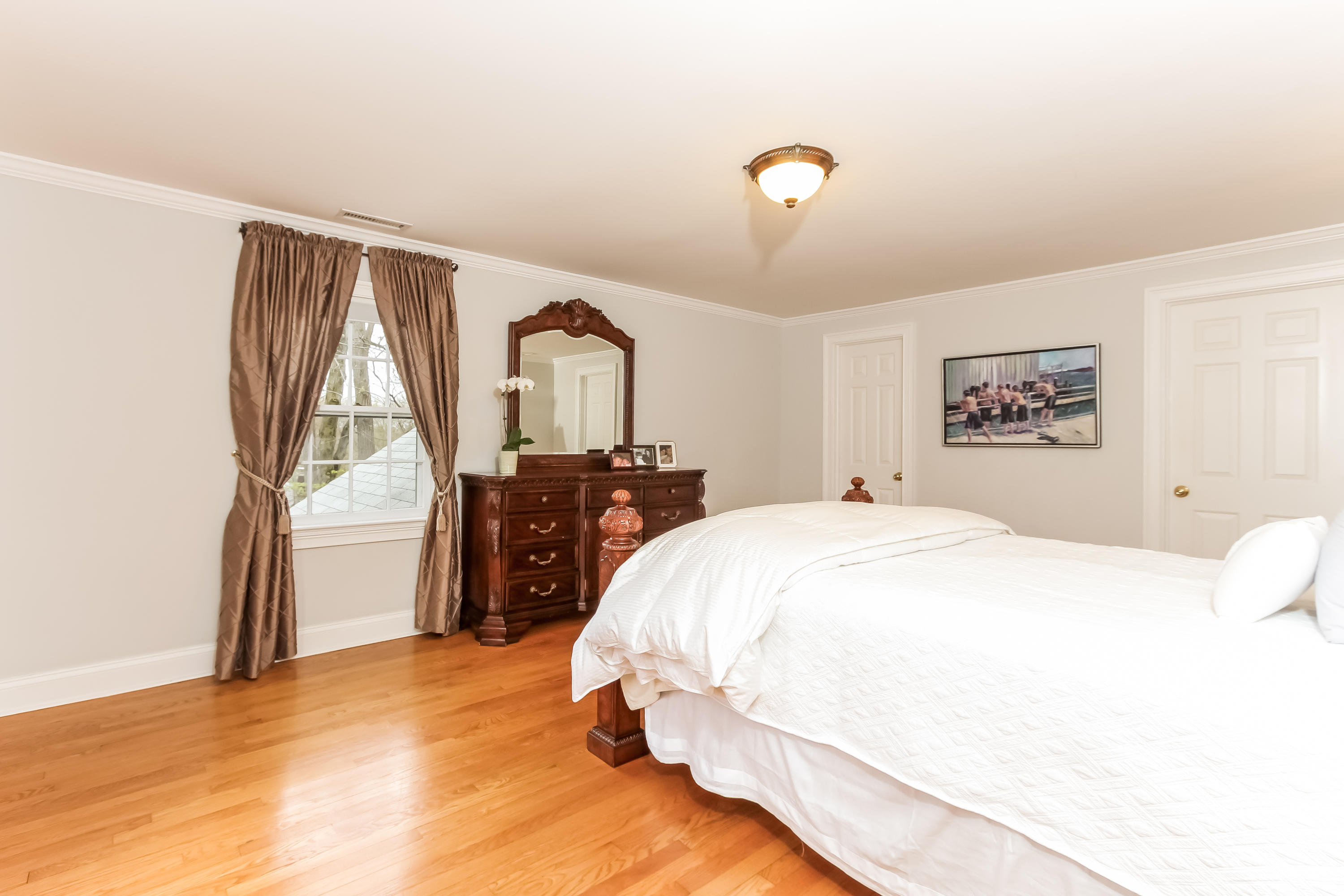 31 Miller Road Darien, CT 06820 - Photo 17 of 29 a spacious bedroom with a bed and a large window