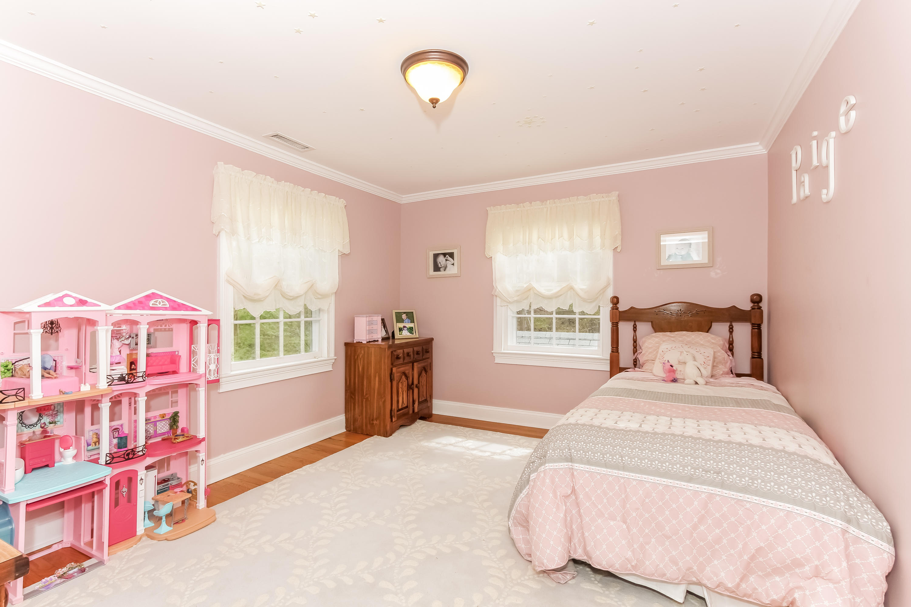 31 Miller Road Darien, CT 06820 - Photo 20 of 29 a bedroom with a bed next to a window and a chandelier