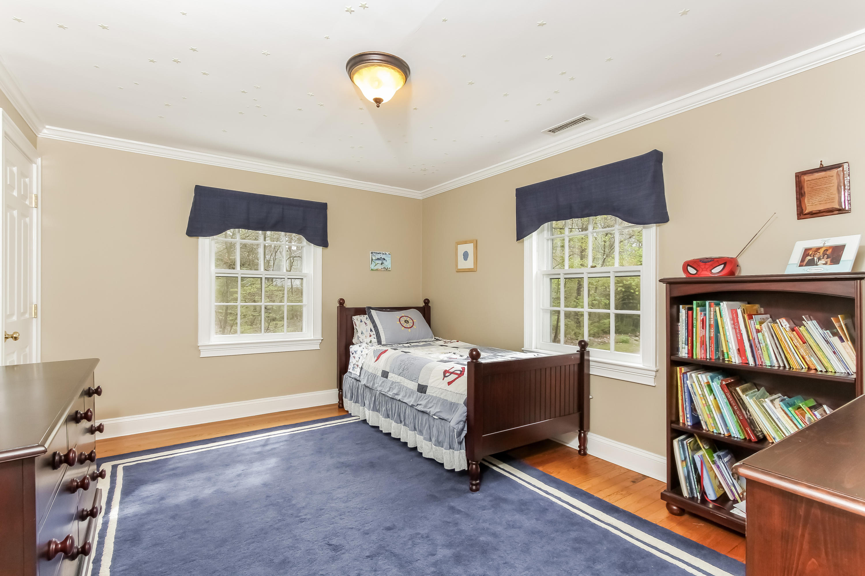 31 Miller Road Darien, CT 06820 - Photo 21 of 29 a bed room with a bed and a book shelf
