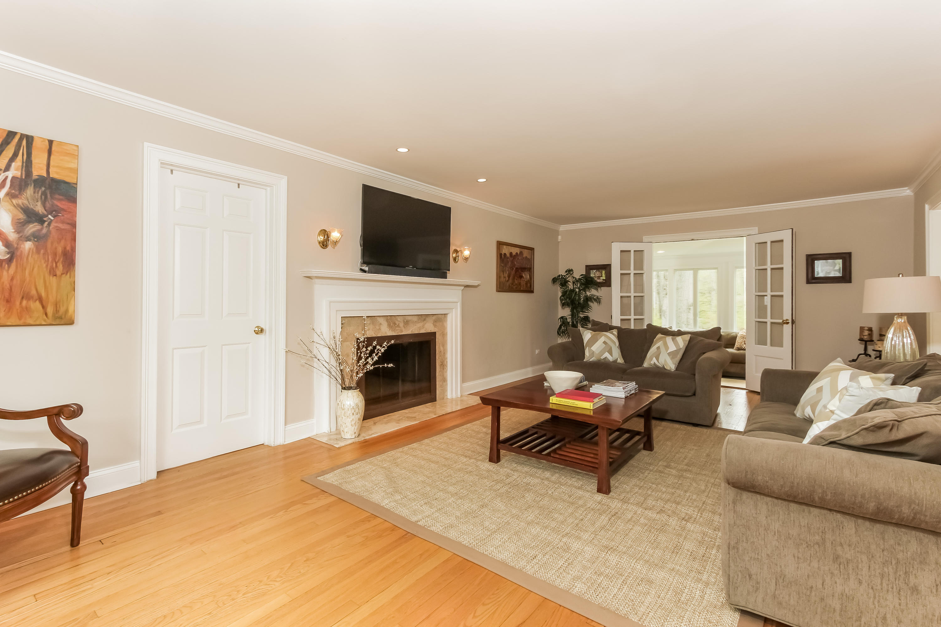 31 Miller Road Darien, CT 06820 - Photo 4 of 29 a living room with furniture a fireplace and a flat screen tv