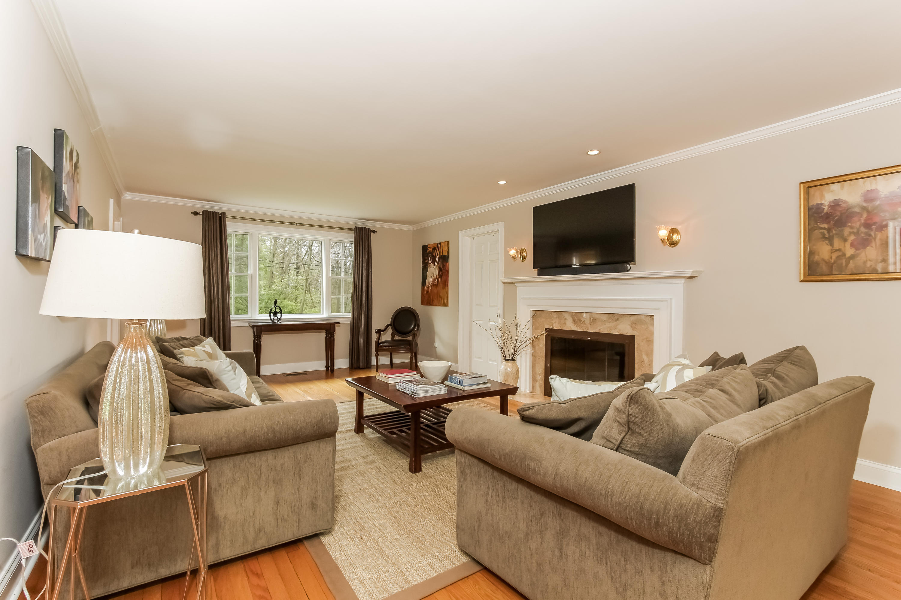 31 Miller Road Darien, CT 06820 - Photo 5 of 29 a living room with furniture a flat screen tv and a fireplace