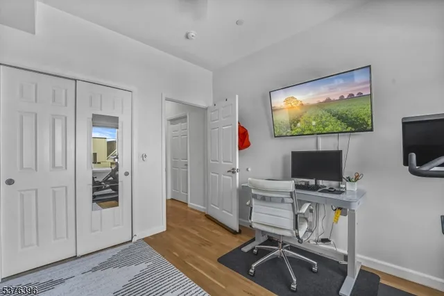 a view of a workspace with furniture and wooden floor