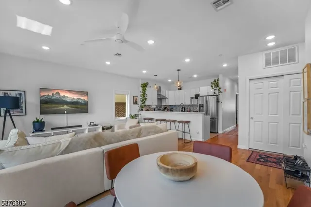 a large living room with stainless steel appliances furniture