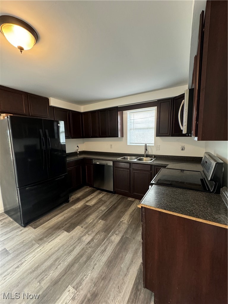 5155 Center Road Philo, OH 43771 - Photo 11 of 37 Kitchen featuring sink, stove, fridge, dishwashing machine, and hardwood / wood-style flooring