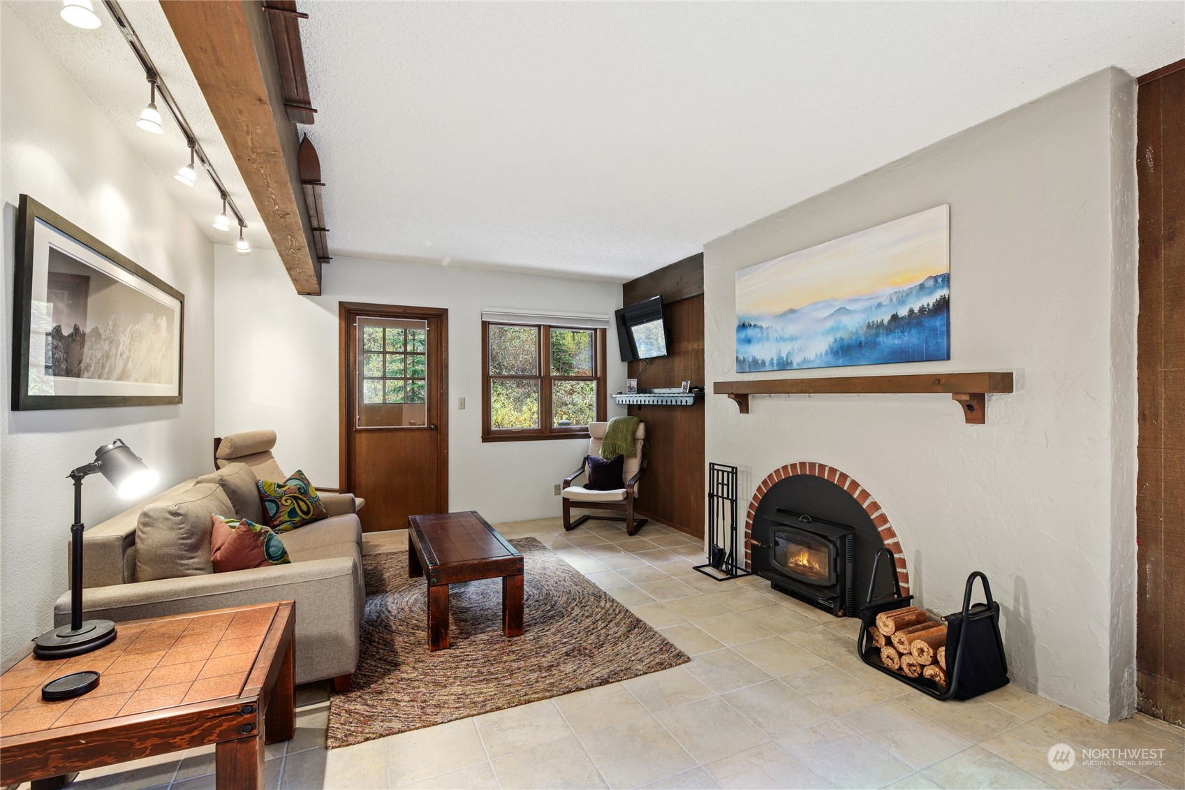 17700 Alpental Access Road, Unit 1006 Snoqualmie Pass, WA 98068 - Photo 1 of 26 a living room with furniture and a fireplace