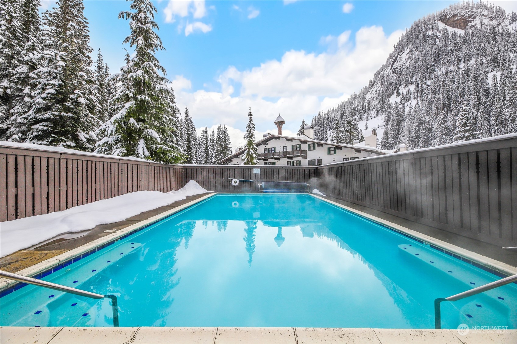 17700 Alpental Access Road, Unit 1006 Snoqualmie Pass, WA 98068 - Photo 2 of 26 a view of a swimming pool with a yard