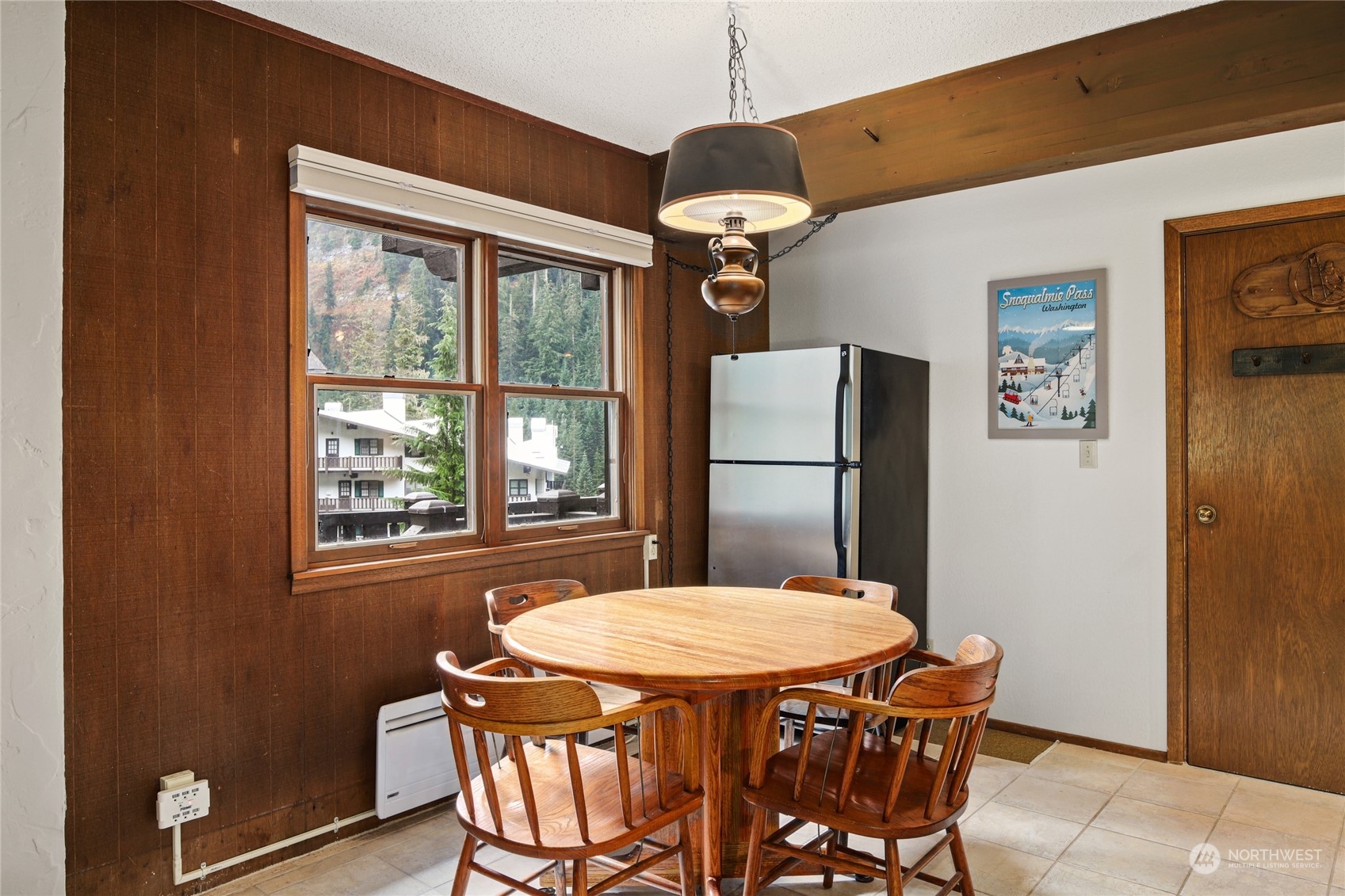 17700 Alpental Access Road, Unit 1006 Snoqualmie Pass, WA 98068 - Photo 6 of 26 a kitchen that has a table chairs and refrigerator