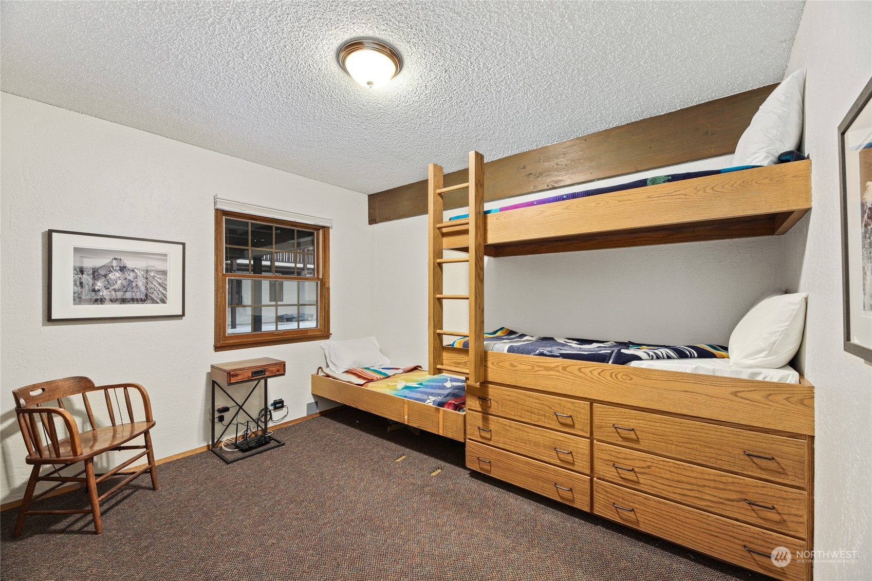 17700 Alpental Access Road, Unit 1006 Snoqualmie Pass, WA 98068 - Photo 8 of 26 a bed room with a bed and a chair