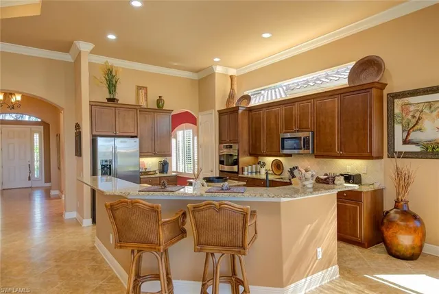 a kitchen with a sink appliances and cabinets