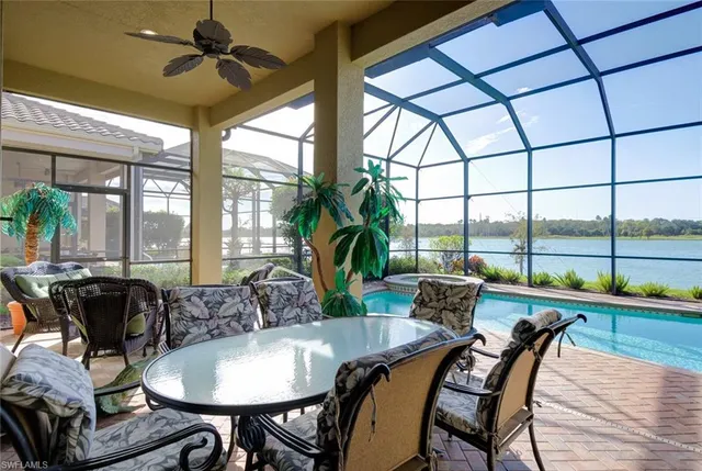 a dining room with furniture a chandelier and wooden floor