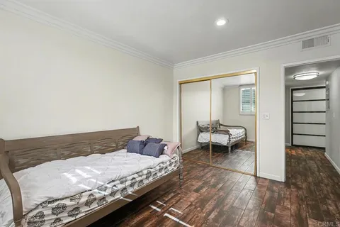 a bedroom with a bed and a mirror