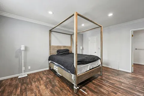 a bedroom with a bed and a ceiling fan