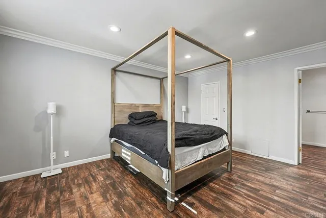 a bedroom with a bed and a ceiling fan