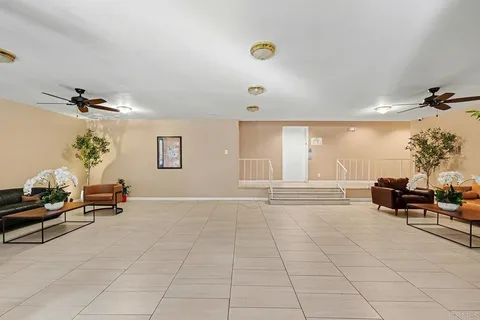 a bedroom with furniture and a potted plant