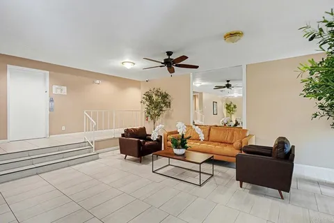 a view of a house with backyard sitting area and swimming pool