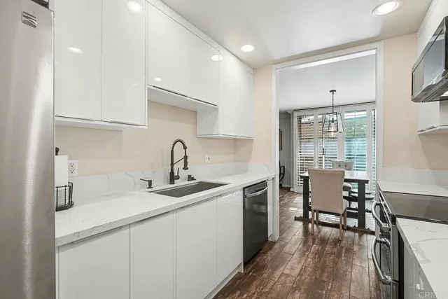 a kitchen with a sink cabinets and wooden floor