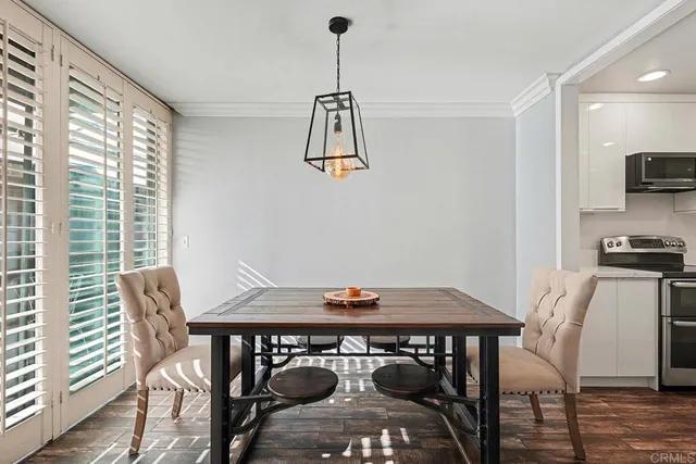 a view of a dining room with furniture window and wooden floor