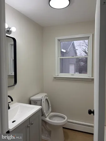 a bathroom with a toilet sink and mirror