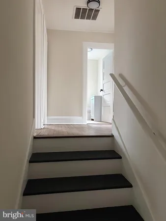a view of an empty room window and wooden floor