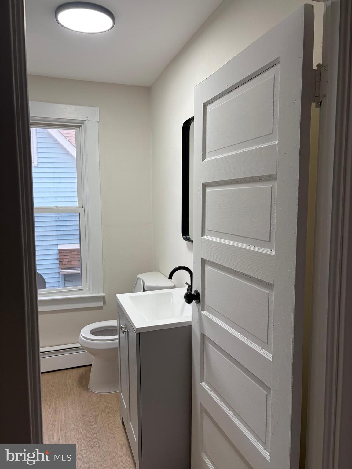 33 Johnson Street Salem, NJ 08079 - Photo 22 of 33 a bathroom with a toilet sink and mirror