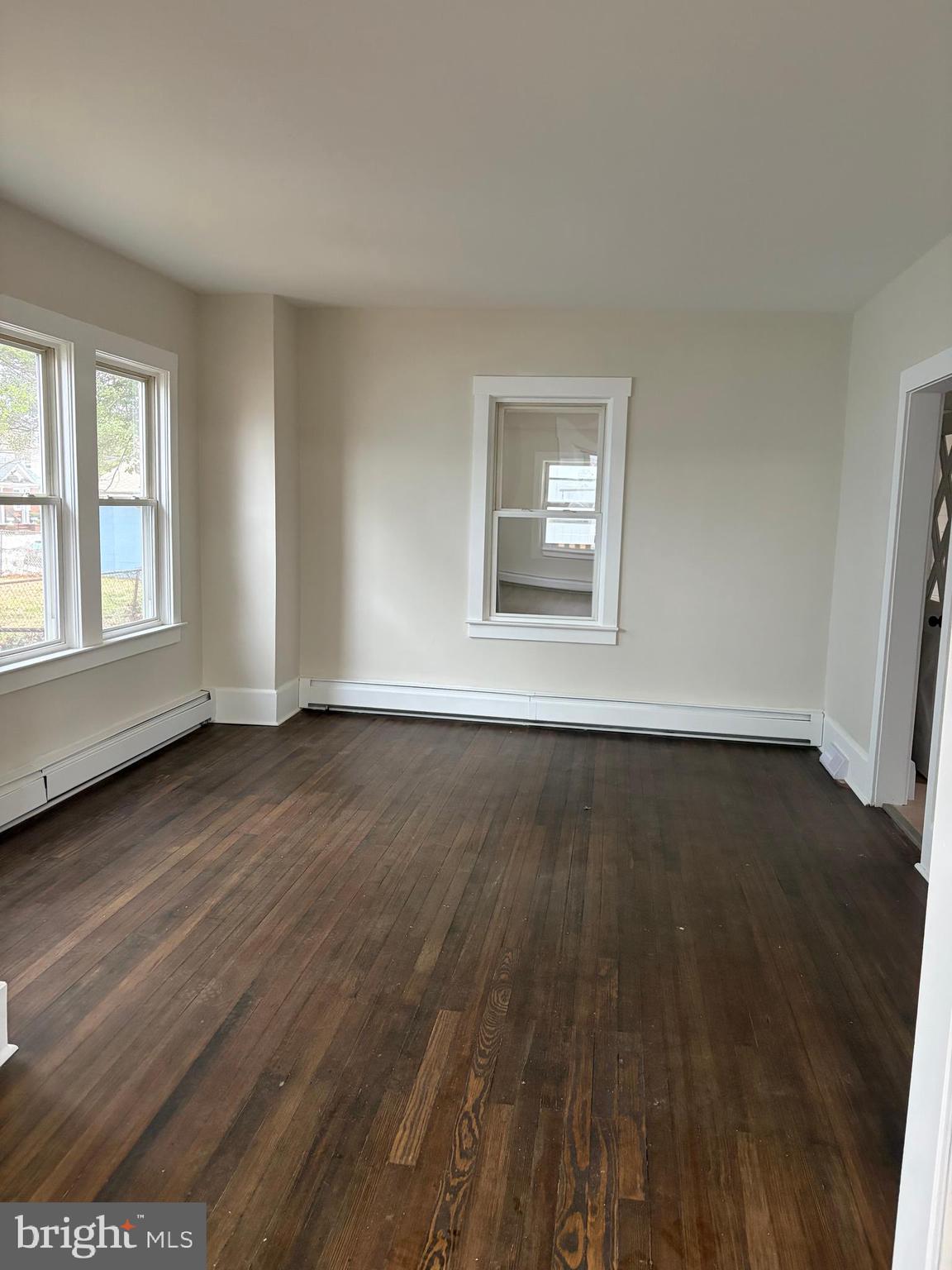 33 Johnson Street Salem, NJ 08079 - Photo 5 of 33 an empty room with wooden floor and windows