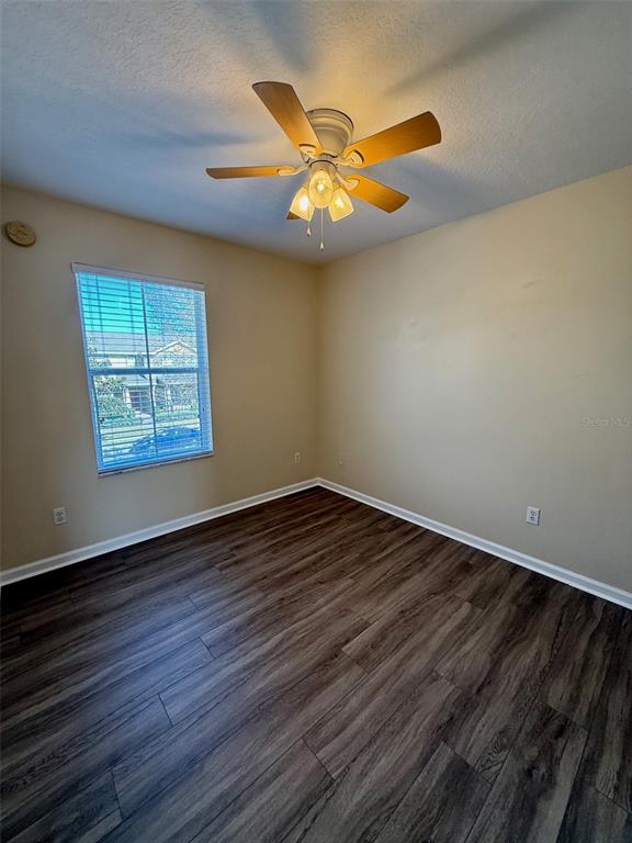 11912 Deer Path Way Orlando, FL 32832 - Photo 19 of 21 a view of an empty room with wooden floor and a window