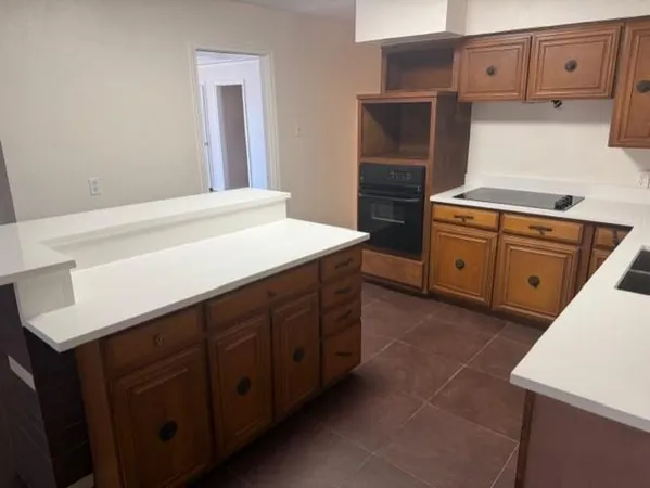 a kitchen with cabinets and window