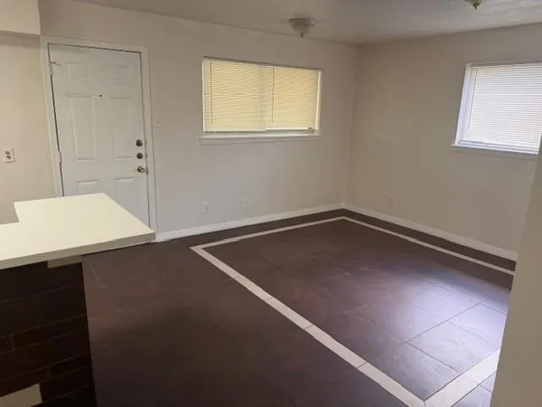 a view of a room with wooden floor and fan